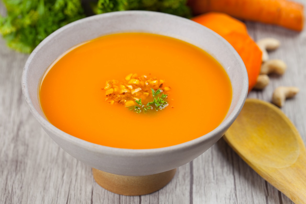 Creamy carrot soup with roasted nuts